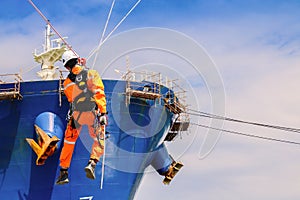 The staff show the abseiling from the height, Close up pic of male rope access jobs worker wearing white hardhat, long sleeve shir