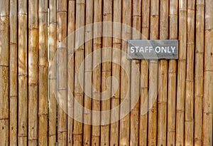 Staff Only sign on bamboo wall