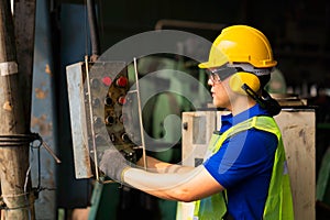 Staff or technicians are checking the operation of the old machine via the tablet