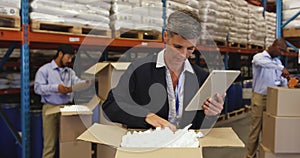 Staff in a warehouse packing boxes for delivery 4k