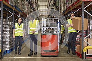 Staff at work in the aisle of a busy distribution warehouse