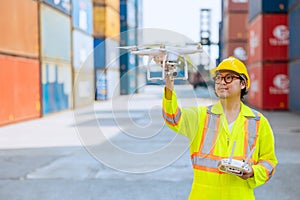 Staff worker using Drone aerial imaging system in port container yard. UAV Patrol flying guard technology for survey and security