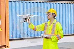 Staff worker using Drone aerial imaging system in port container yard. UAV Patrol flying guard technology for survey and security