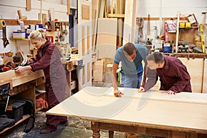 Staff Working In Busy Carpentry Workshop