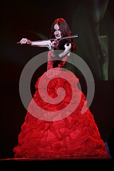 On stage - beautiful, frail and slender girl with fiery red hair - a well-known musician, virtuoso violinist Maria Bessonova.