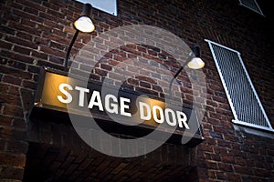 Stage door at London theatre illuminated by spotlights