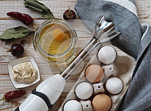 The stage of making homemade mayonnaise from natural healthy ingredients.A jar with ready made mayonnaise, vegetable oil, eggs and