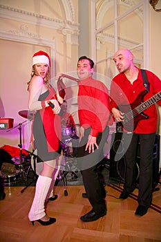 On stage, the musicians pop-rock group Spearmint and singer Anna Malysheva. red . Red headed Glam Rock Girl singing.