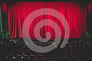 Stage with velvet red curtain in theater cinema, empty old-fashioned elegant theatre wooden stage with red cloth drapes curtains