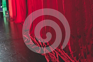 Stage with velvet red curtain in theater cinema, empty old-fashioned elegant theatre wooden stage with red cloth drapes curtains