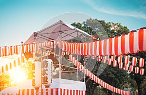 The stage of the Yaguro. Paper red-white lanterns Chochin Scenery for the holiday Obon when people dance of Bon Odori