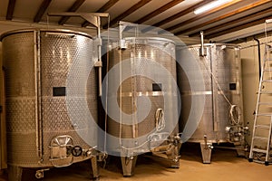 Stages of wine production from fermentation to bottling, visit to wine cellars in Burgundy, France. Steel vats for fermentation