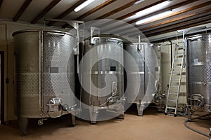 Stages of wine production from fermentation to bottling, visit to wine cellars in Burgundy, France. Steel vats for fermentation