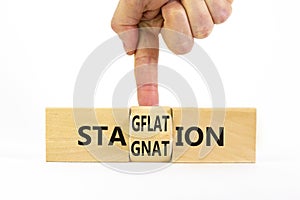 Stagflation or stagnation symbol. Businessman turns cubes, changes the word stagnation to stagflation. Beautiful white table,