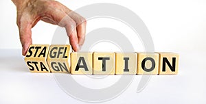 Stagflation or stagnation symbol. Businessman turns cubes, changes the word stagnation to stagflation. Beautiful white table white