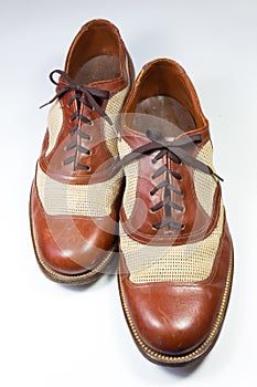 Staggered view of a pair of vintage men`s shoes in brown leather