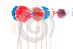 Staggering row of lollipops fading into background photo