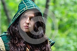 Staging photo of beautiful woman in fantasy suit with hood