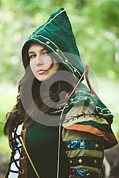 Staging photo of beautiful woman in fantasy suit with hood