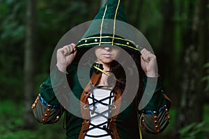 Staging photo of beautiful woman in fantasy suit with hood