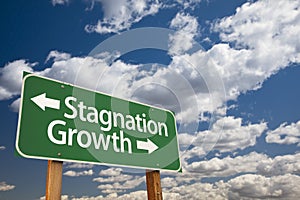 Stagnation or Growth Green Road Sign Over Clouds and Sky photo
