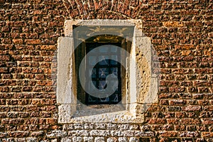 Stain Glass Window against a brick wall