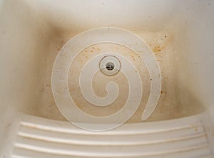 Stained and Dirty White Sink with Years of Neglect
