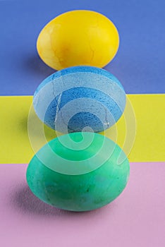 Stained Easter eggs as an attribute of Easter celebration on colorful background