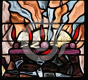 Stained Glass of a burning lamb, symbolizing the Agnus Dei