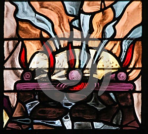 Stained Glass of a burning lamb, symbolizing the Agnus Dei photo