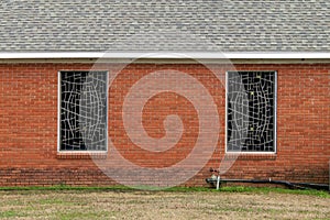 Stained glass church windows red brick wall