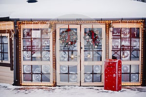 Stained glass doors decorated with Christmas wreaths for Christmas and winter holidays