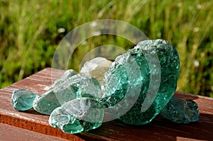 Stained, glass, glasswork, smoothed, rounded, river, collected, children, transparent, wooden, table, brown, turquise, blue, red,