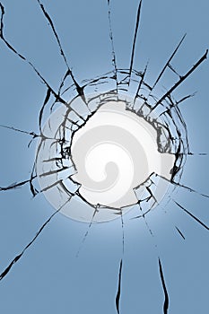 Stained glass with a hole in the middle on a blue background. Texture of black cracks and white background in the center