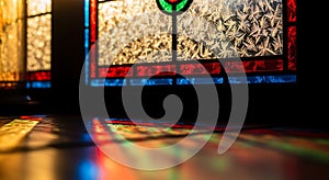 Stained glass light patterns on floor on
