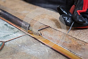 Stained glass maker works with souvenirs