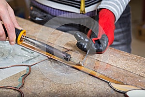 Stained glass maker works with souvenirs