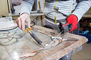 Stained glass maker works with souvenirs