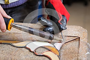 Stained glass maker works with souvenirs