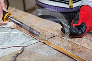 Stained glass maker works with souvenirs