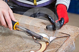 Stained glass maker works with souvenirs