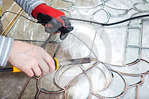 Stained glass maker works with souvenirs