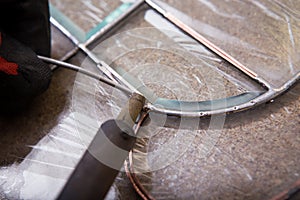 Stained glass maker works with souvenirs