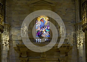 Stained glass window of the ascendance of Mary, inside the Milan Cathedral, the cathedral church of Milan, Lombardy, Italy.