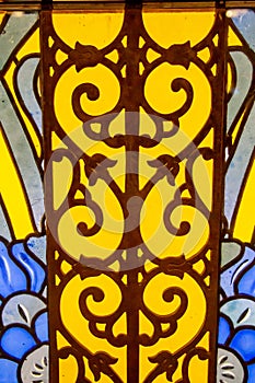 The stained glass window is bright and beautiful in the form of an ornate pattern of yellow blue color. World tourism