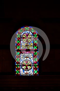 Stained glass window with colorful abstract patterns in a church