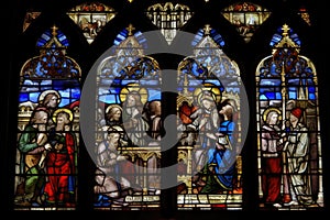 stained glass window, depicting a religious scene, in medieval cathedral