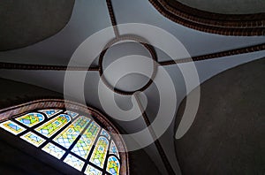 Stained glass window in old cathedral or church. Beautiful colored glass window. Day lighting