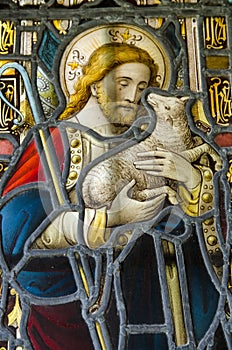 Stained glass window showing Jesus holding a lamb