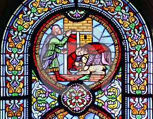 Stained glass window showing sacrificing the lamb photo